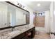 Bright bathroom featuring granite counters, a large mirror, and a tub/shower combo at 430 Holly Stream Trl, Roswell, GA 30075