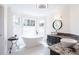 A modern bathroom has a soaking tub, vessel sinks, and granite counters at 430 Holly Stream Trl, Roswell, GA 30075