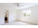 A neutrally decorated bedroom has a window, closet, and ensuite bathroom at 430 Holly Stream Trl, Roswell, GA 30075