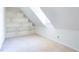 Attic bedroom with built-in shelving for storage and a bright window at 430 Holly Stream Trl, Roswell, GA 30075