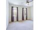 Neutral bedroom with a ceiling fan and dual windows providing ample natural light at 430 Holly Stream Trl, Roswell, GA 30075