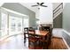 Light filled dining room featuring wood floors, a fireplace, and staircase at 430 Holly Stream Trl, Roswell, GA 30075