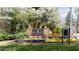 Stone monument sign for Wildwood Springs, surrounded by colorful flowers and lush greenery at 430 Holly Stream Trl, Roswell, GA 30075