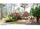 Traditional two-story brick home featuring mature landscaping, a welcoming entrance, and classic architectural details at 430 Holly Stream Trl, Roswell, GA 30075