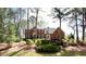 Charming two-story brick home with well-manicured landscaping and mature trees at 430 Holly Stream Trl, Roswell, GA 30075