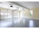 Spacious garage with epoxy floor, windows, and three garage doors at 430 Holly Stream Trl, Roswell, GA 30075