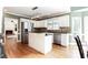 This is a spacious kitchen featuring stainless appliances, an island, and light wood floors at 430 Holly Stream Trl, Roswell, GA 30075