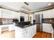 White kitchen featuring stainless steel appliances, an island, and granite counters at 430 Holly Stream Trl, Roswell, GA 30075