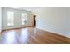 Bright living room with hardwood floors, white walls, and a large window at 430 Holly Stream Trl, Roswell, GA 30075