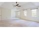 This large main bedroom has neutral carpet and several windows at 430 Holly Stream Trl, Roswell, GA 30075