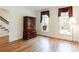 Bright room with hardwood floors, two windows, and traditional furniture at 430 Holly Stream Trl, Roswell, GA 30075