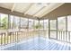 Covered screened porch featuring blue wood flooring and a ceiling fan, perfect for outdoor relaxation and entertaining at 430 Holly Stream Trl, Roswell, GA 30075