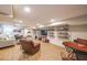 Finished basement living area with wood-look floors, comfy seating, sports decor, and game table at 4537 Ashmore Cir, Marietta, GA 30066