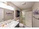 This relaxing bathroom features a glass shower, marble countertop, built-in shelves and tiled floor at 4537 Ashmore Cir, Marietta, GA 30066