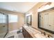 Bathroom with a double sink vanity, granite counters, and a glass enclosed shower at 4537 Ashmore Cir, Marietta, GA 30066