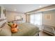 This primary bedroom features an ample window, hardwood floors, and is decorated in soothing, neutral earth tones at 4537 Ashmore Cir, Marietta, GA 30066