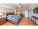 Spacious main bedroom with hardwood floors, a ceiling fan, and a tray ceiling at 4537 Ashmore Cir, Marietta, GA 30066
