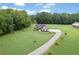 An aerial view of a lovely one-story home with a long driveway surrounded by trees at 340 Taylor Path, Dallas, GA 30157
