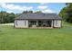 Large backyard features a covered patio, a spacious lawn, and shade trees at 340 Taylor Path, Dallas, GA 30157