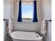 Elegant bathroom featuring soaking tub with dark fixtures and beautiful natural light at 340 Taylor Path, Dallas, GA 30157