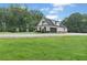 View of the side of the home showing the garage and extensive lawn at 340 Taylor Path, Dallas, GA 30157