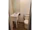Bathroom with a unique pedestal sink and toilet against a white wall at 3905 Hunters Chase, Conyers, GA 30094