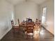 Dining room with wood table, wood chairs, and wood laminate floors at 3905 Hunters Chase, Conyers, GA 30094