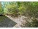 View of densely wooded backyard with gentle slope at 837 Forrest Se Cir, Atlanta, GA 30354