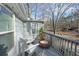 Back balcony with two chairs and a view of the wooded backyard at 837 Forrest Se Cir, Atlanta, GA 30354