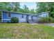 Charming single-story home featuring light blue siding, a front deck, and a well-maintained lawn with mature trees at 837 Forrest Se Cir, Atlanta, GA 30354