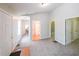 Spacious hallway featuring neutral carpeting, white walls, and multiple doorways leading to various rooms in the home at 837 Forrest Se Cir, Atlanta, GA 30354