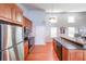 Well-lit kitchen featuring stainless steel appliances, wooden cabinetry, and a functional design perfect for entertaining at 837 Forrest Se Cir, Atlanta, GA 30354