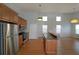 Spacious kitchen with stainless steel appliances, wooden cabinets, and a central island overlooking the open floor plan at 837 Forrest Se Cir, Atlanta, GA 30354