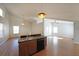 Open kitchen featuring a breakfast bar, hardwood floors, and a view of the spacious living area with vaulted ceilings at 837 Forrest Se Cir, Atlanta, GA 30354