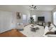 Bright living room with hardwood floors, a ceiling fan, and plenty of natural light from the surrounding windows at 837 Forrest Se Cir, Atlanta, GA 30354