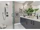 Modern bathroom featuring a glass-enclosed shower and double vanity with sleek, black fixtures at 1160 Ormewood Ave # 13, Atlanta, GA 30316
