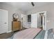 Cozy bedroom with neutral tones, a wooden dresser, and multiple doorways at 1160 Ormewood Ave # 13, Atlanta, GA 30316
