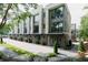 A row of modern townhomes with gray siding, large windows and landscaping at 1160 Ormewood Ave # 13, Atlanta, GA 30316