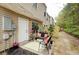 Charming back patio with seating, landscaping, and view of the property exterior at 1501 Eastern Sunrise Ln, Decatur, GA 30034
