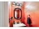 A modern bathroom featuring a granite vanity with sink, an ornate mirror, towels, and a decorative light fixture at 1501 Eastern Sunrise Ln, Decatur, GA 30034