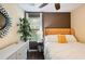 Comfortable bedroom featuring a patterned accent wall, nice window view and hardwood floors at 1501 Eastern Sunrise Ln, Decatur, GA 30034