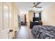 Open view of bedroom with a ceiling fan, tv, mirror, sofa, and a large window at 1501 Eastern Sunrise Ln, Decatur, GA 30034