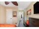 Bedroom featuring a ceiling fan, a decorative mirror, neutral paint and a glimpse into a hallway at 1501 Eastern Sunrise Ln, Decatur, GA 30034
