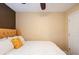 Bedroom featuring a patterned accent wall, plush white bedding and hardwood floors at 1501 Eastern Sunrise Ln, Decatur, GA 30034