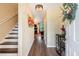 Inviting hallway featuring wood floors, elegant lighting and staircase leading to the upper level at 1501 Eastern Sunrise Ln, Decatur, GA 30034