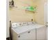 Bright laundry room featuring a full-size washer and dryer set and shelving unit for storage at 1501 Eastern Sunrise Ln, Decatur, GA 30034
