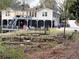 Spacious backyard featuring a home with a deck, screened porch, a trampoline, and attractive stone landscaping at 4002 Wieuca Ne Rd, Atlanta, GA 30342