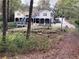 Spacious backyard with a two-story home, a deck, a screened porch, a trampoline, and stone landscaping at 4002 Wieuca Ne Rd, Atlanta, GA 30342