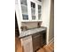 Convenient bar area featuring granite countertop, wine cooler, and glass-front cabinets for stylish entertaining at 4002 Wieuca Ne Rd, Atlanta, GA 30342