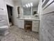 Elegant bathroom featuring decorative tile flooring, an ample vanity, and white cabinetry at 4002 Wieuca Ne Rd, Atlanta, GA 30342